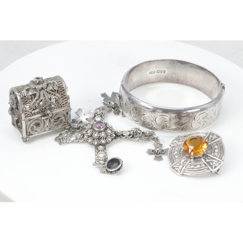 141 - A silver hallmarked bangle, Mexican silver cross pendant, silver Celtic style brooch, filagree chest... 