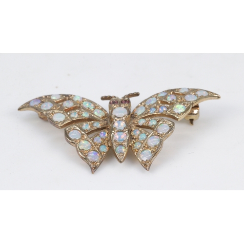 142 - A 9ct gold butterfly brooch set with opals and ruby eyes
