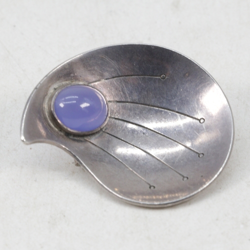 140 - A sterling silver brooch marked Rey Urban to reverse set with blue stone
