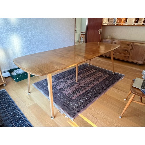 277 - An Ercol grand dining table with extension table