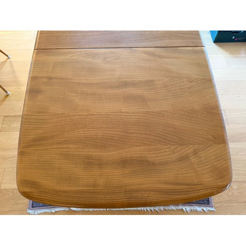 277 - An Ercol grand dining table with extension table