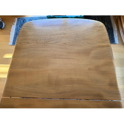 277 - An Ercol grand dining table with extension table