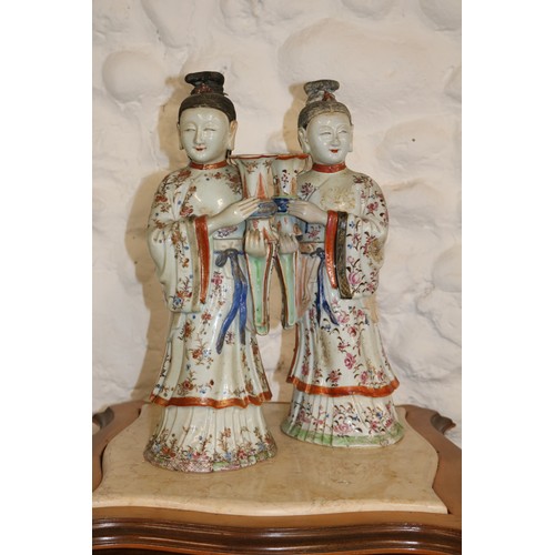 A Pair of Chinese Famille rose Export maidens as candlesticks, Qian long. Circa 1760/70.