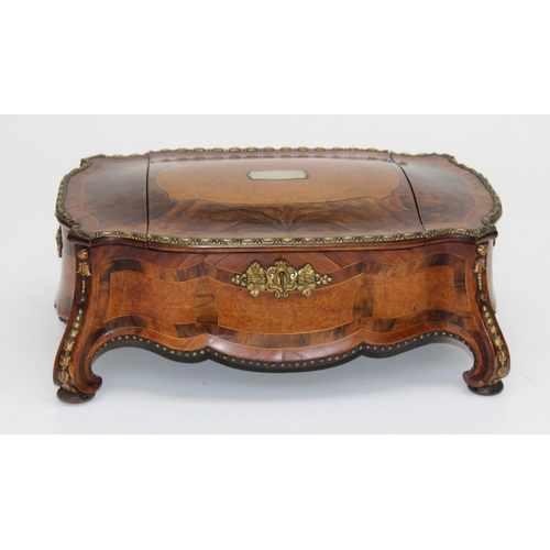 A Louis XV Palais Royal ormulu mounted, oyster, kingwood and burr veneer jewellery box, the triple hinged cover enclosing a divided interior raised on scroll feet. 39cm wide