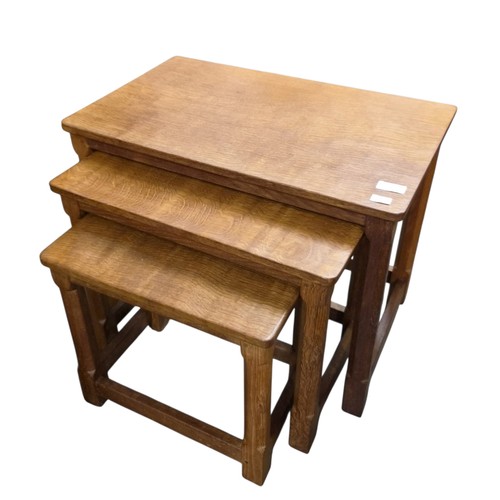 Robert Mouseman Thompson; a set of three oak rectangular intersliding tables; with adzed finish and each with carved mouse signature to one of the legs