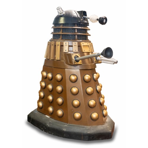 Doctor Who: A lifesize example of a Doctor Who Dalek Jast, constructed by Robert Phillips. This model of the Dalek is fully electric, with powered dome and eyestalk movement, additionally fitted with a water gun based on a 100 psi fountain pump, and Martmod MK5 Number 1. Fully motorised with joystick control. Both light cages and gun are made from aluminium, with hemis and dome in fibreglass, with everything else being handmade. The vendor informs us that the Dalek was fully working when originally purchased around 2-3 years ago, but the battery is currently flat, with the model being built on the chassis of a mobility scooter. The underside of the head unit has been signed by previous members of the cast and production team including: Jon Davey, Barnolby Edwards, Nick Briggs, Terry Malloy, and Dan Starkey. The model measures approximately 170cm. Please assess photographs. 