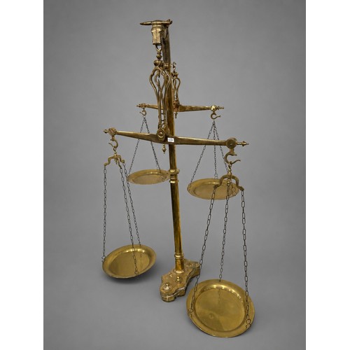 Monumental Portuguese Floor Standing Brass Butchers Double Beam Scales Features a Central Column Surmounted a Distinctive Bulls Head Finial Complete with Weights