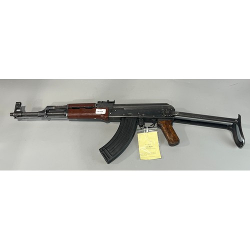 Deactivated Contract AK47 Kalashnikov Sub Machine Gun 7.62mm, 16 1/4 Inch Barrel with Front Hooded Sight Top Mounted Gas Port. Rear Body With Ladder Sight. Pressed Steel Top Cover. Right Side Cocking Handle. Rear Blued, Pressed Steel Folding Butt. Wooden Pistol Grip. Steel Trigger Guard and Blued Magazine Composite, Two Part Forend. Steel Ramrod. Complete With Current Cert