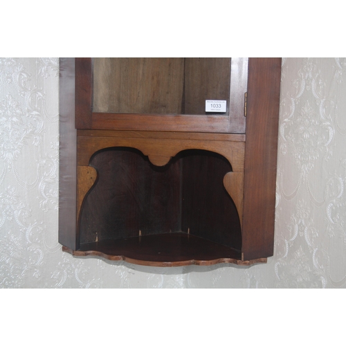 1033 - An Edwardian mahogany glazed corner unit