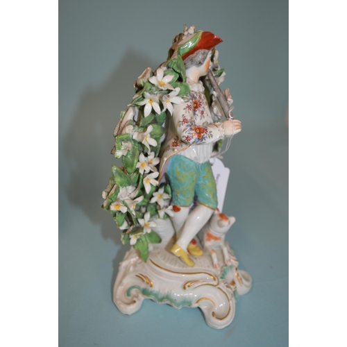 120 - Two early 19th Century continental porcelain figurines, the man with dog surrounded by a bocage, 7 1... 