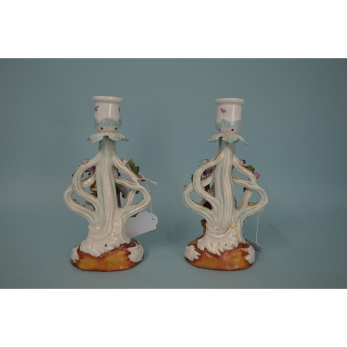 121 - A pair of 19th Century German porcelain candlestick figurines, blue crossed mark to base, hand paint... 