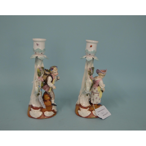 121 - A pair of 19th Century German porcelain candlestick figurines, blue crossed mark to base, hand paint... 