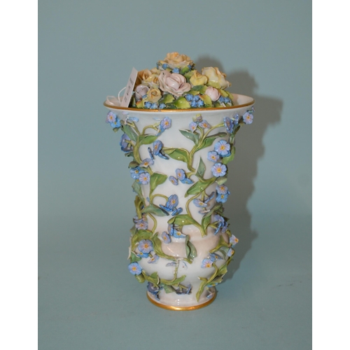 122 - An early 19th Century porcelain flower encrusted lidded vase, Meissen style blue cross sword marks t... 