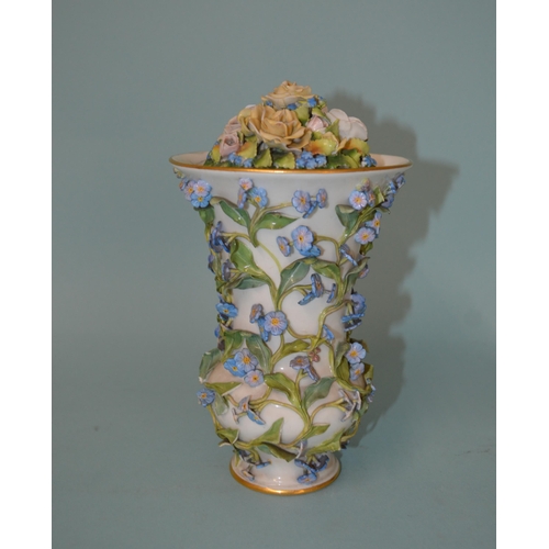 122 - An early 19th Century porcelain flower encrusted lidded vase, Meissen style blue cross sword marks t... 