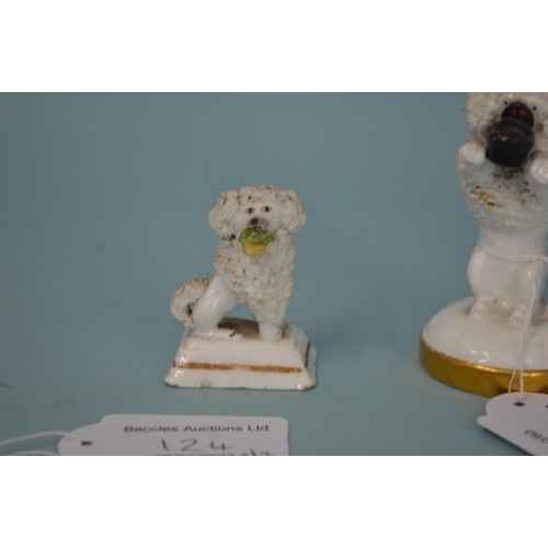 124 - Three 19th Century Staffordshire porcelain poodles, the larger with hat in mouth on gilded base, 3