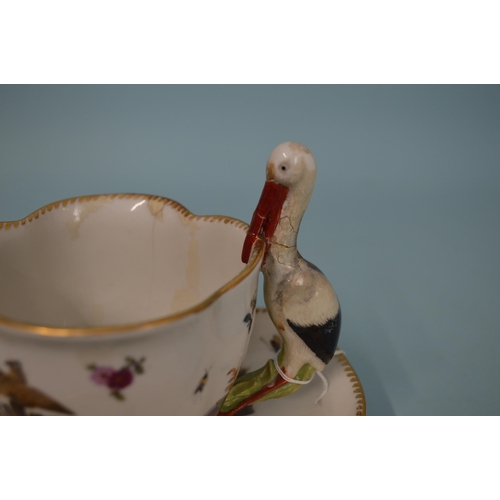 131 - A late 18th Century Meissen porcelain hand painted cup and saucer, blue crossed swords marks to base... 