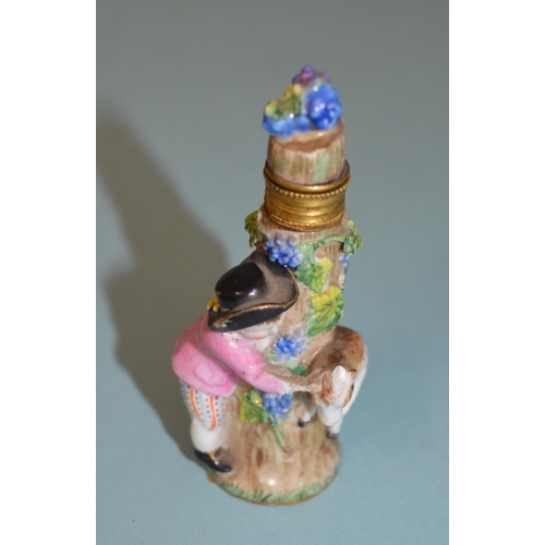 136 - Two late 18th Century/early 19th Century porcelain figural perfume bottles, each modelled as a figur... 