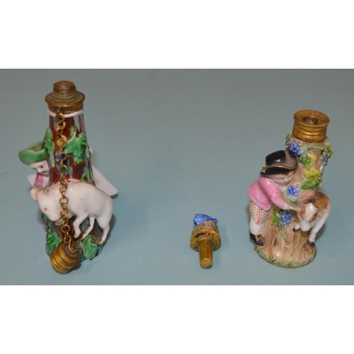 136 - Two late 18th Century/early 19th Century porcelain figural perfume bottles, each modelled as a figur... 