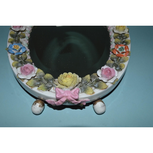 139 - An early 20th Century Dresden flower encrusted dressing table mirror with cherub, wood mounted easel... 