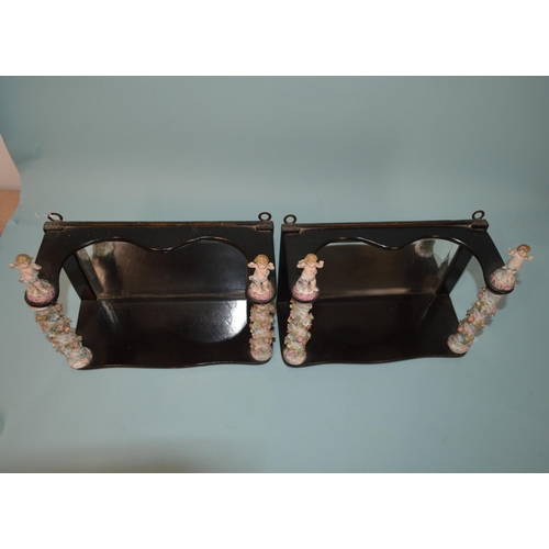 140 - A pair of early 20th Century wooden with mirror back wall shelves with Dresden style porcelain colum... 