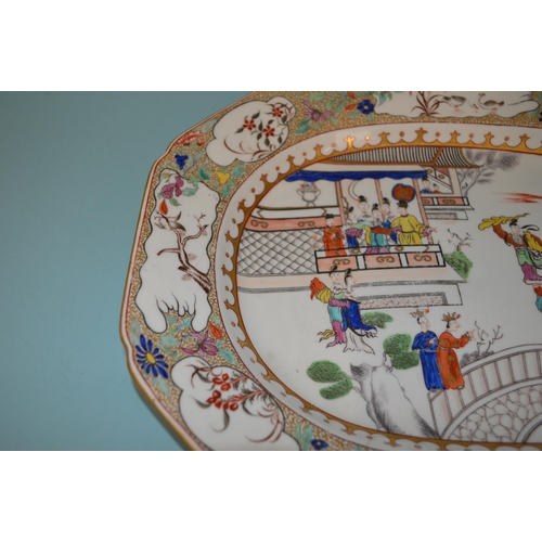 142 - An 18th Century porcelain platter in the Chinese manner, hand painted with figures, floral border wi... 