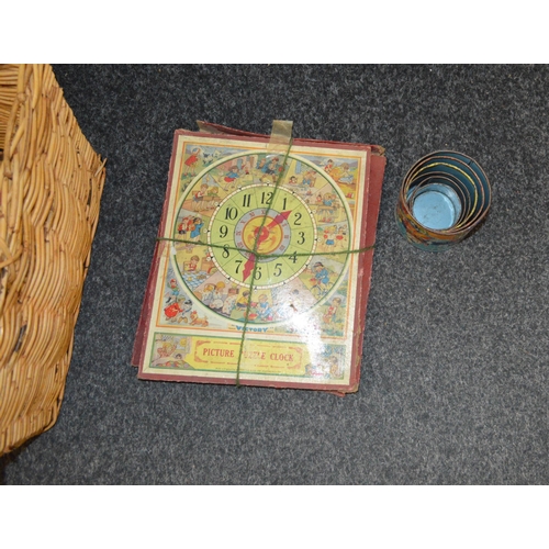 16 - A basket of vintage children's games including picture puzzle clock, Tri-ang colour spell bricks, a ... 