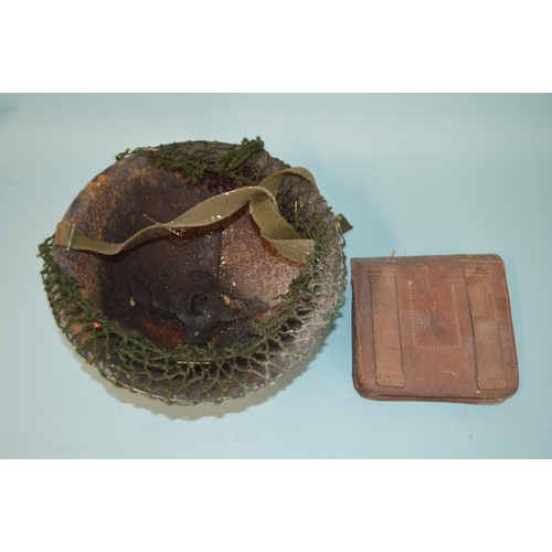 172 - A WWII era Army helmet (rusty) plus a WWI military trench saw (rusty)