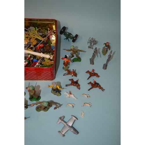 18 - A biscuit tin of various vintage lead and plastic figures plus four lead horses and riders (as found... 