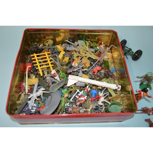 18 - A biscuit tin of various vintage lead and plastic figures plus four lead horses and riders (as found... 