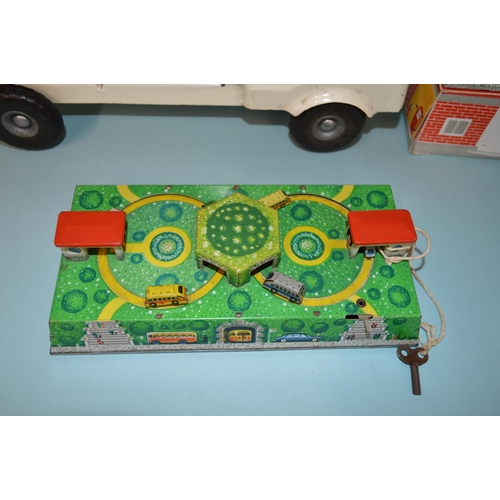 19 - Two Russian made tin plate clockwork car toys plus a Tri-ang tin plate transport truck, 14 1/4