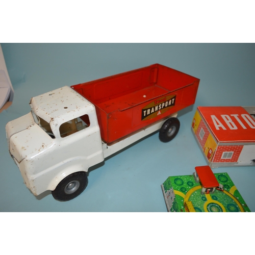 19 - Two Russian made tin plate clockwork car toys plus a Tri-ang tin plate transport truck, 14 1/4