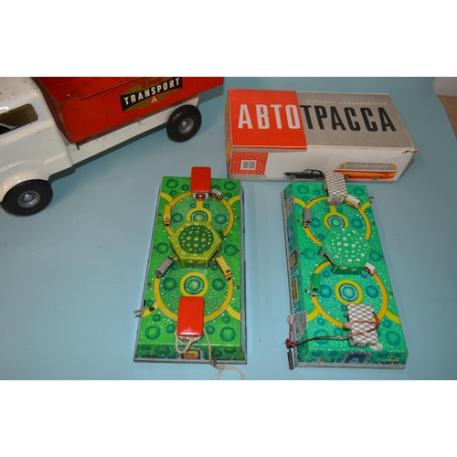 19 - Two Russian made tin plate clockwork car toys plus a Tri-ang tin plate transport truck, 14 1/4