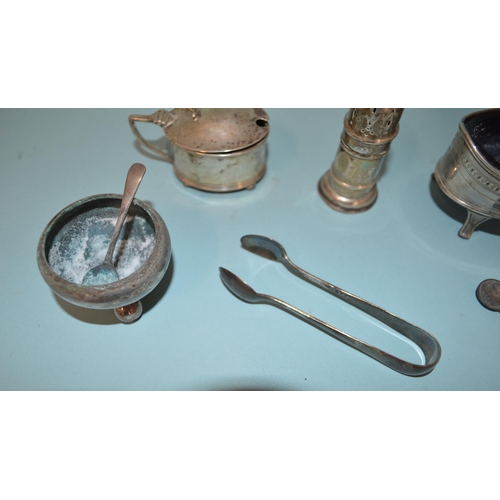 21 - A selection of hallmarked silver condiments including a large Georgian salt etc (most with salt dama... 