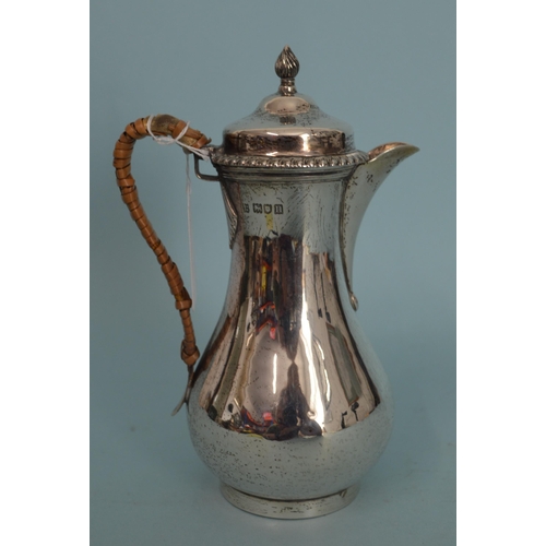 29 - An Edwardian hallmarked silver small hot water lidded jug, London 1908, makers marks rubbed, 7 1/4