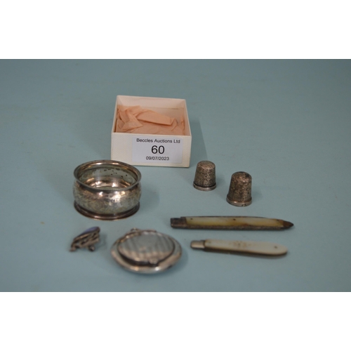 60 - A mixed lot of vintage hallmarked silver items including penknives, a napkin ring, thimbles, New Zea... 