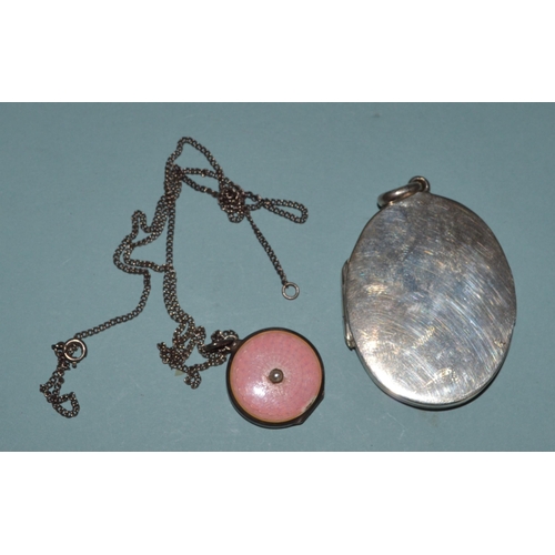 65 - A hallmarked silver locket plus a white metal and enamel smaller example