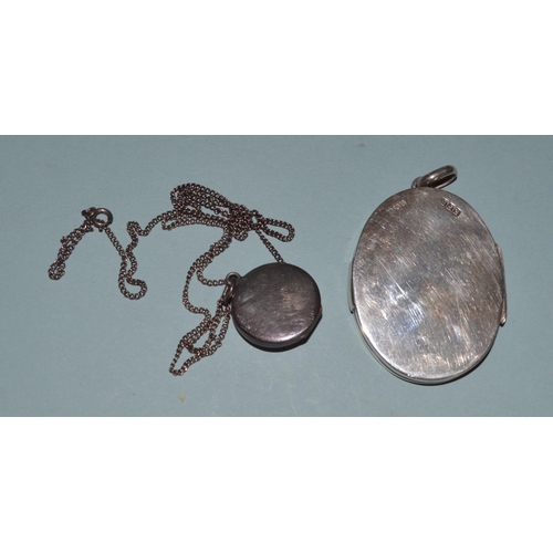 65 - A hallmarked silver locket plus a white metal and enamel smaller example