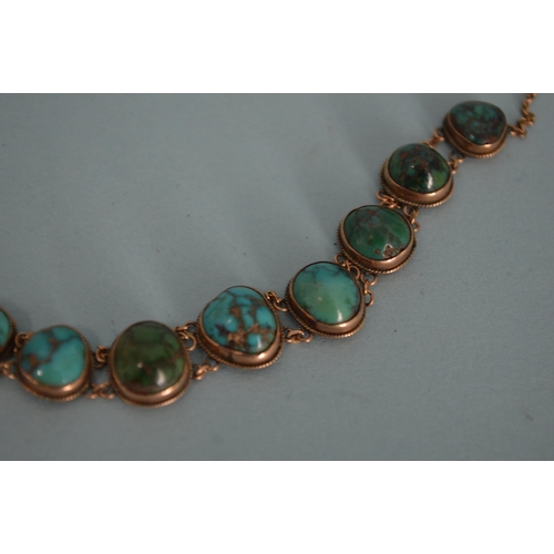 67 - A 9ct gold stone blue set necklace, 15