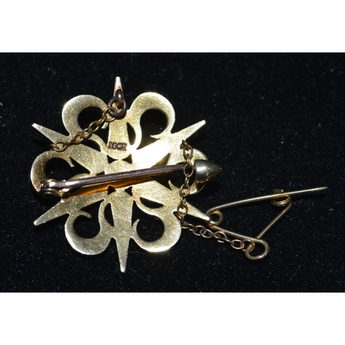 77 - A 15ct gold pearl set brooch with safety chain (two pearls missing)