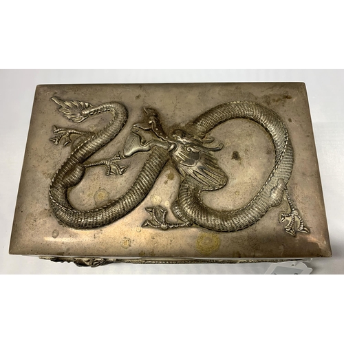 163 - A fine Oriental white metal and wood lined cigar box, elaborately decorated with dragons on all side... 