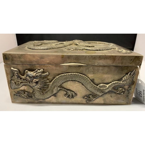 163 - A fine Oriental white metal and wood lined cigar box, elaborately decorated with dragons on all side... 