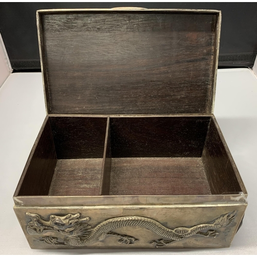 163 - A fine Oriental white metal and wood lined cigar box, elaborately decorated with dragons on all side... 
