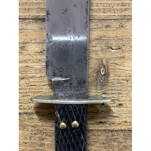 144 - An antique Bowie knife with scabbard, Sheffield made, 11