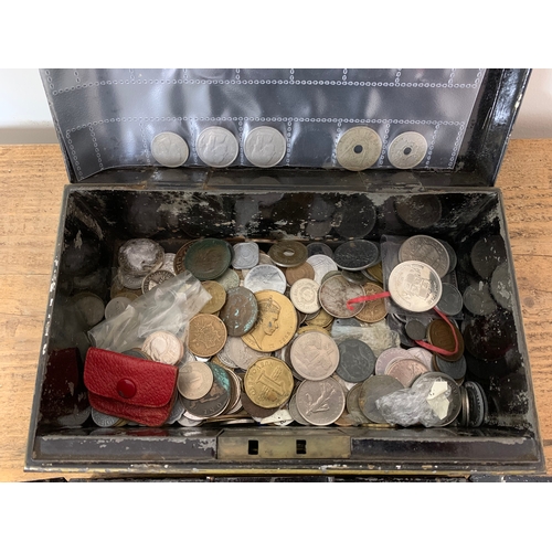 185 - A vintage cash tin with key including a small amount of foreign and British coins