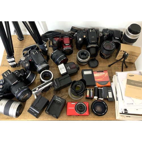 187 - A mixed lot of digital cameras with lenses, leads and instructions etc plus a tripod