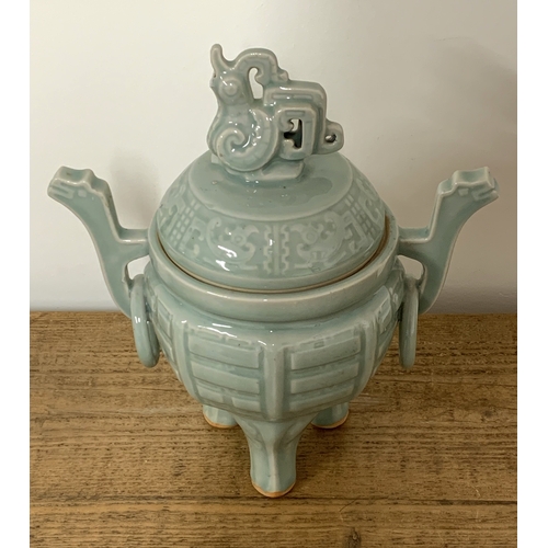 195 - An Oriental celadon glaze lidded jar with animal finial to lid and fixed ring handles, approx. 12 1/... 