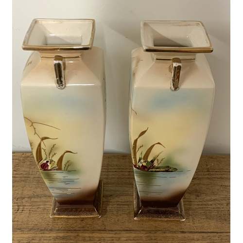 197 - A pair of early 20th Century print and tint vases decorated with birds and over gilding, note attach... 