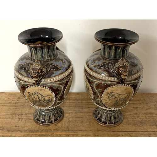 206 - A fine pair of Doulton Lambeth Florence Barlow vases, dated 1877 to base and decorated with four pan... 