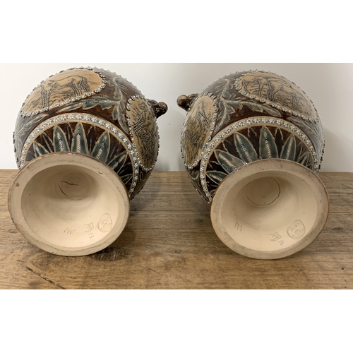 206 - A fine pair of Doulton Lambeth Florence Barlow vases, dated 1877 to base and decorated with four pan... 