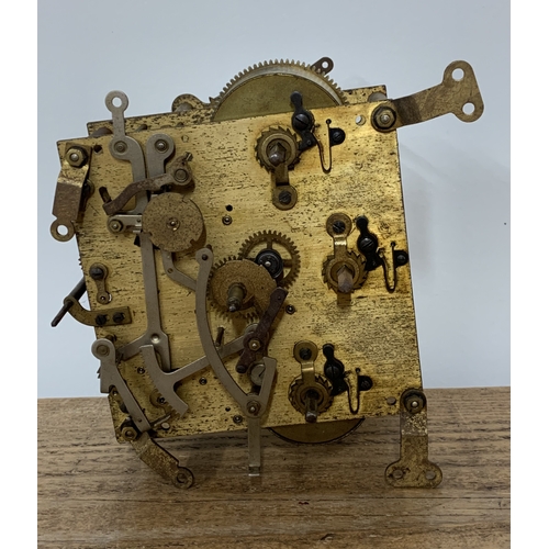 306 - A vintage granddaughter clock movement with pendulum etc